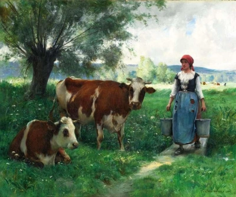 Eine Milchmagd mit ihren Kühen auf der Weide