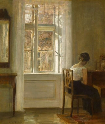 Niña sentada junto a una ventana
