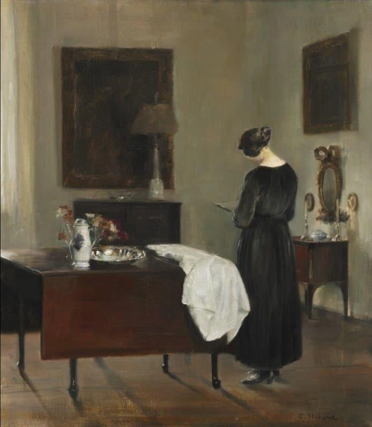Taidemaalarin vaimo kotonaan lukemassa kirjaa